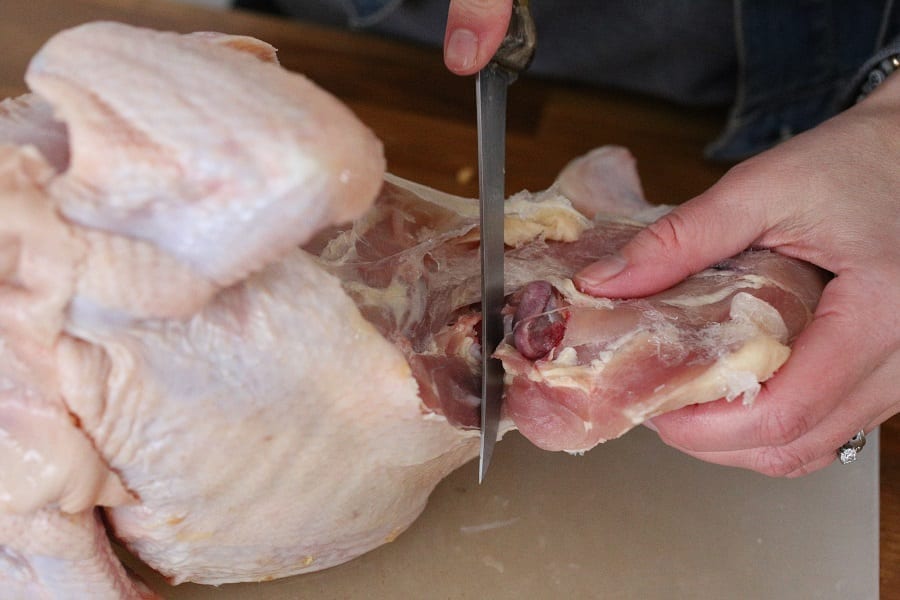 Cutting up a chicken removing the thigh