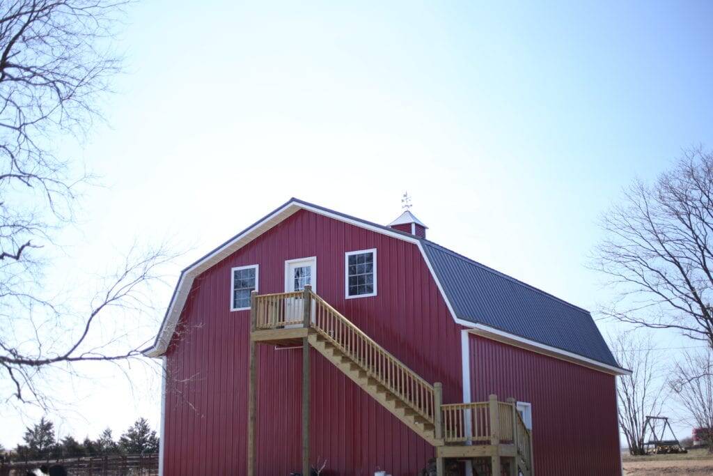 back of red metal pole barn