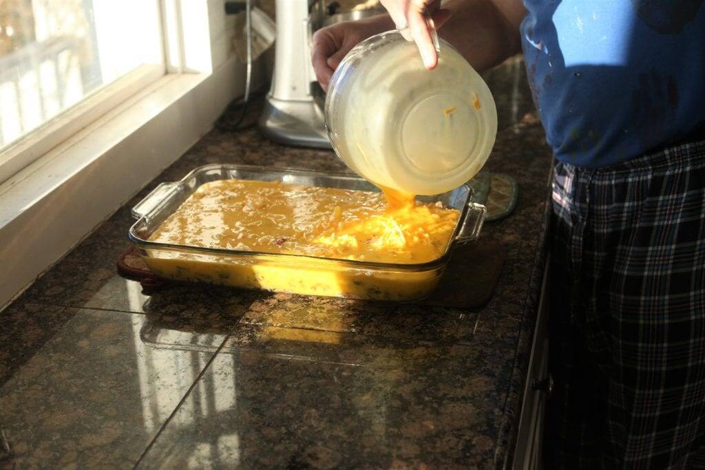 Pouring eggs for casserole