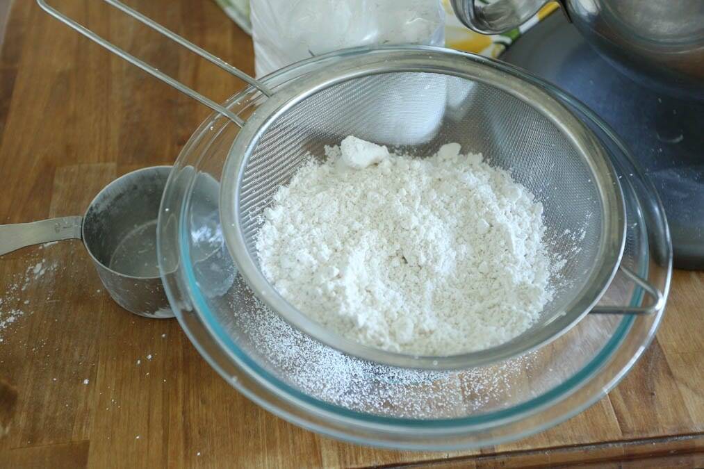 sifting powdered sugar for lemon cream cheese frosting