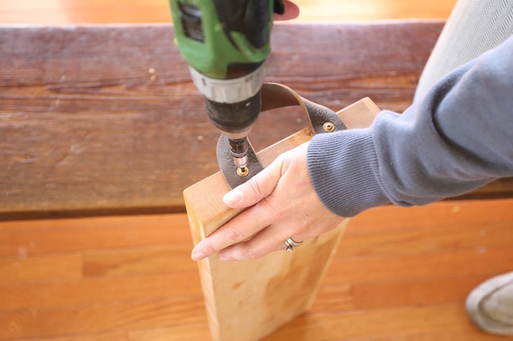 screwing the leather handles into the board