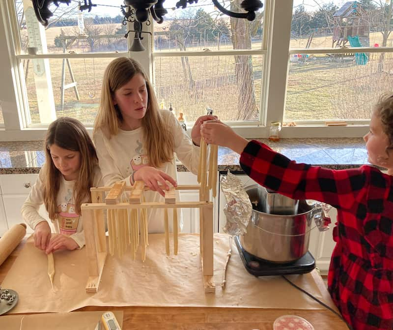 Children hand dipping candles